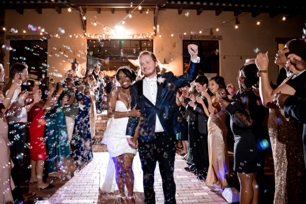bride and groom grand exit with bubbles at Bella Collina wedding venue