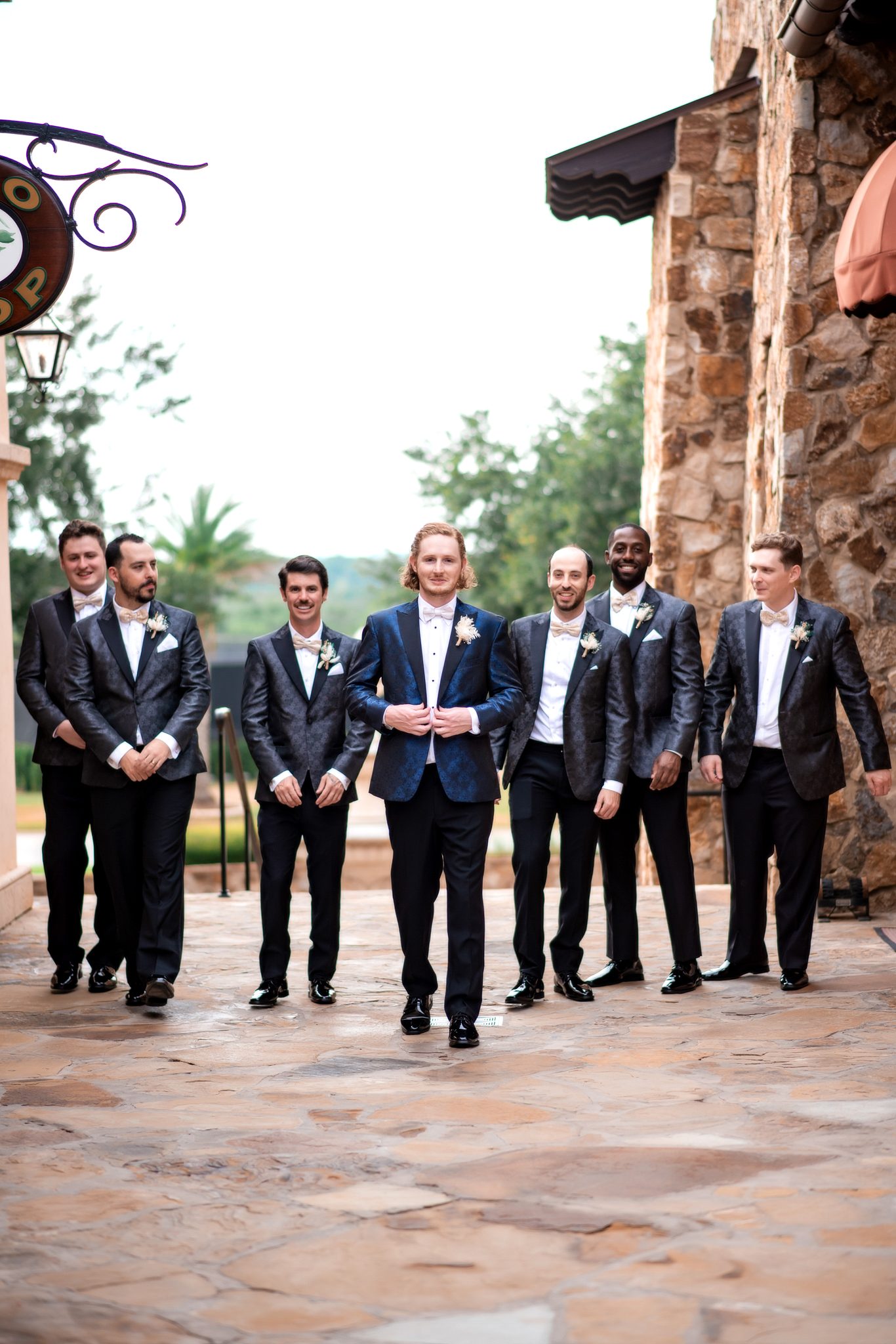 groom with groomsman in matching blue suits