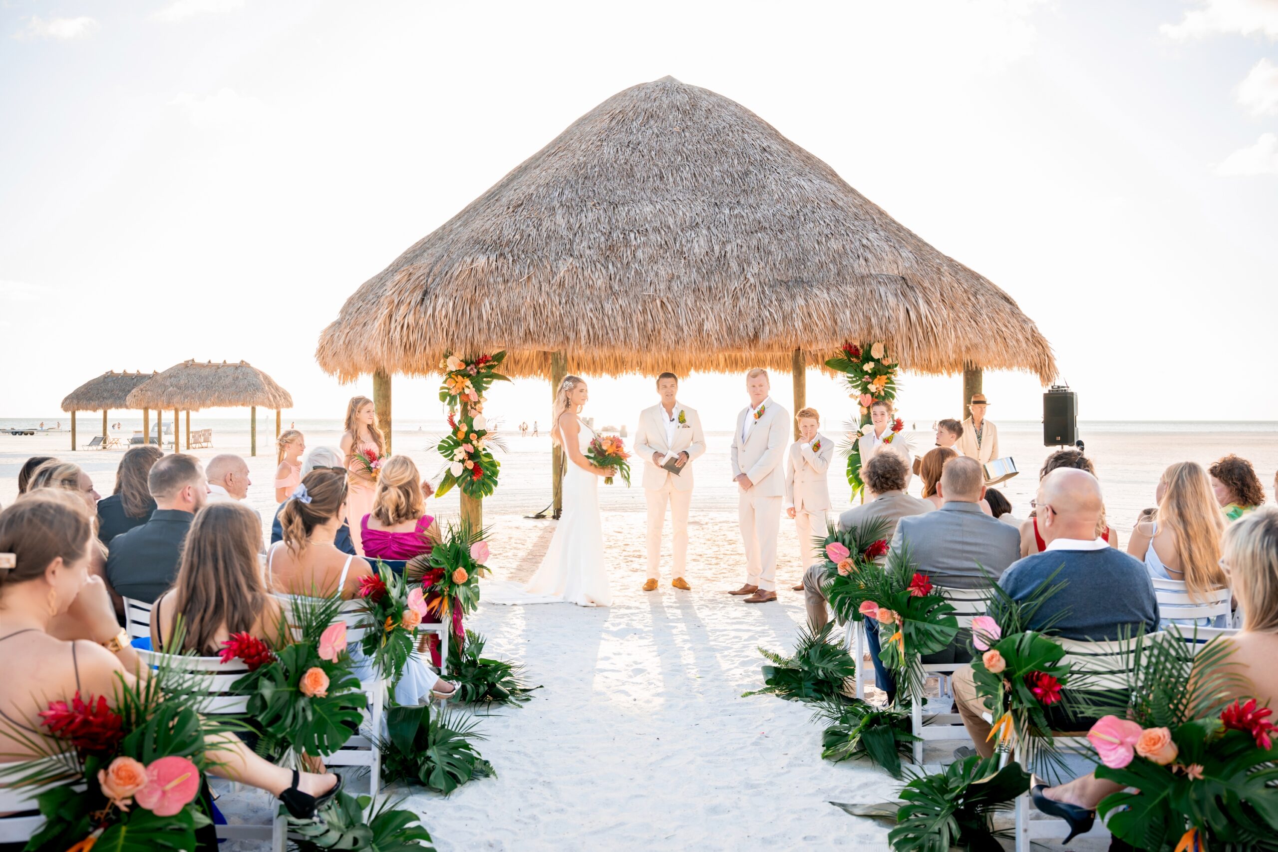 Bride and groom during their JW Marriott Marco Island wedding ceremony at golden hour with ocean backdrop.