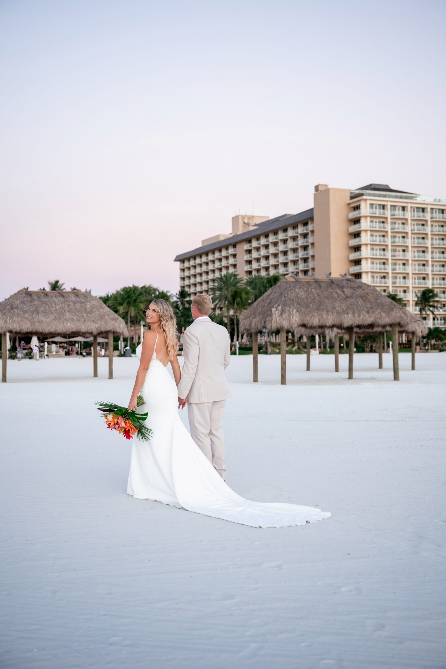 Bride and groom during their JW Marriott Marco Island wedding ceremony at golden hour with ocean backdrop.