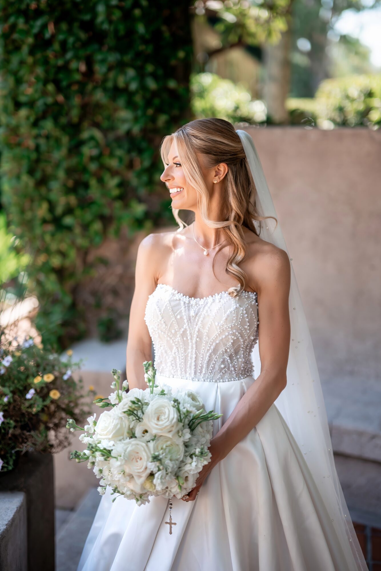 Bride portrait holding her white bouquet in soft natural light