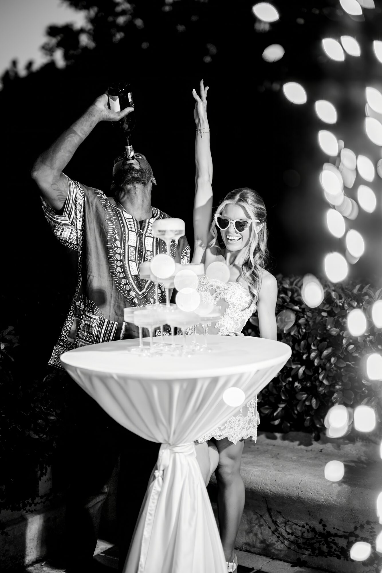 Champagne tower moment at the reception captured in black and white