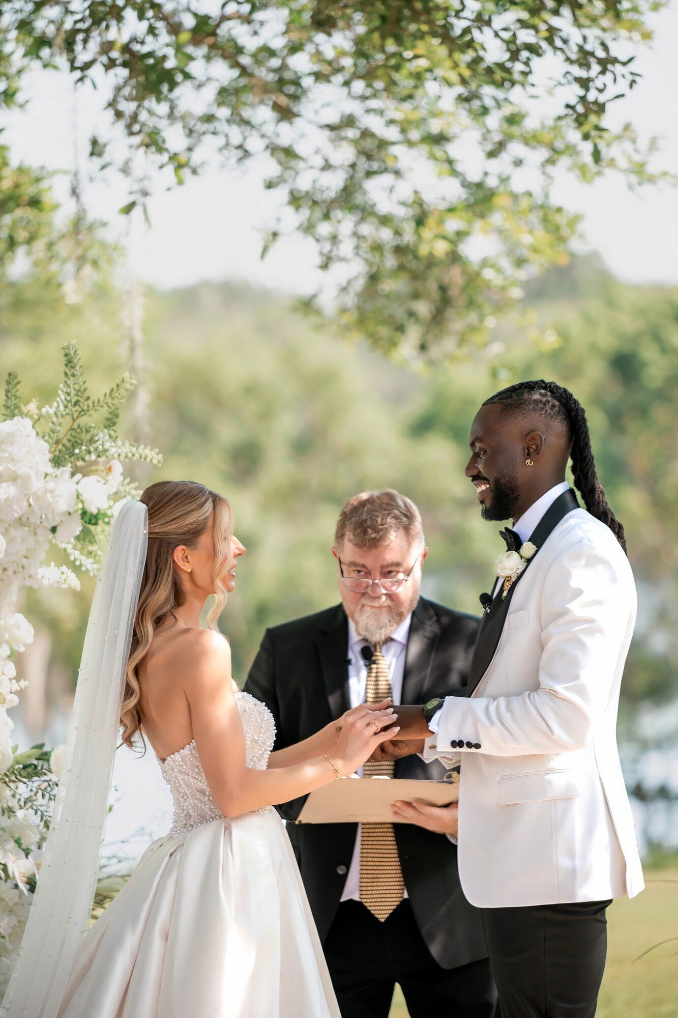 Bride and groom exchange vows at their outdoor Sydonie Mansion ceremony